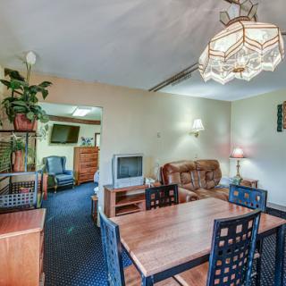 A cozy living and dining space featuring a warm color palette and comfortable furnishings.