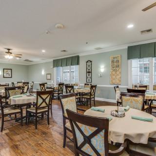 A spacious and well-decorated dining room with neatly arranged tables and chairs.