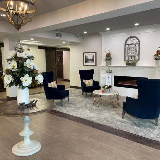 A modern and elegant lobby with comfortable seating, fireplace, and decorative elements.