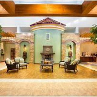 A spacious and elegantly designed lobby area featuring comfortable seating and architectural accents.