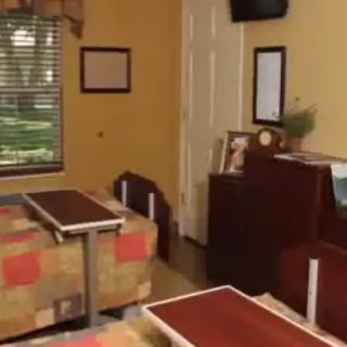 A cozy room with two beds, a TV, and various furnishings.