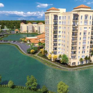 A scenic view of waterfront apartment buildings surrounded by a lake.