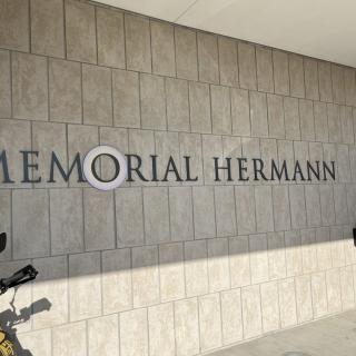 Exterior view of the Memorial Hermann building with a bicycle parked nearby.