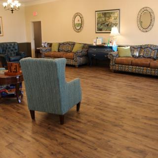 A cozy living room with wooden flooring and comfortable seating arrangements.