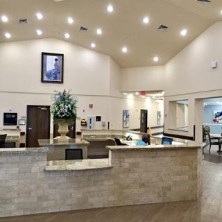A spacious and modern reception area with elegant lighting and floral decor.