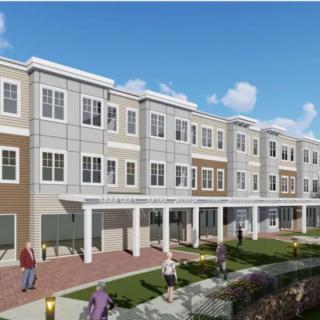 A modern apartment building with a landscaped front area.