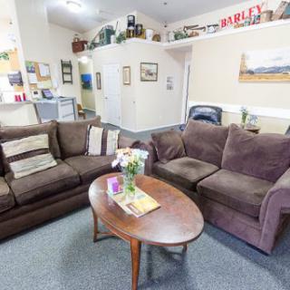A cozy living room featuring comfortable sofas and a wooden coffee table, perfect for gatherings.