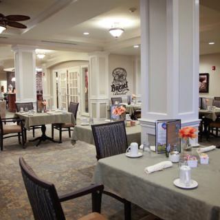 An elegant dining room setting with neatly arranged tables and chairs.