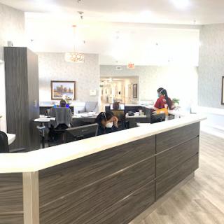 A modern reception area with staff attending to visitors.