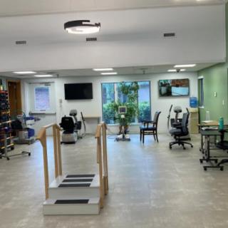 A well-equipped rehabilitation center with various exercise machines and a calming atmosphere.