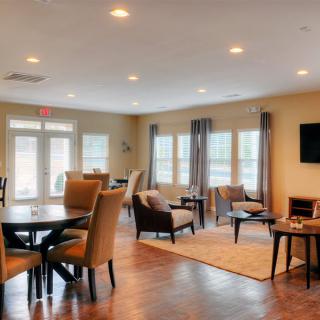 A modern living room with elegant furniture and large windows providing ample natural light.