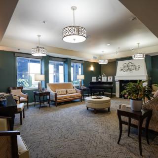 A cozy and elegantly designed living room with comfortable seating, stylish lighting fixtures, and a warm atmosphere.
