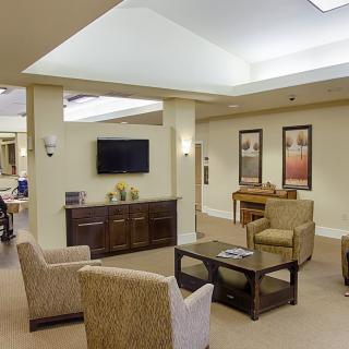 A modern living room with comfortable seating and a wall-mounted television.