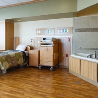 A hospital room equipped with a bed and medical equipment.