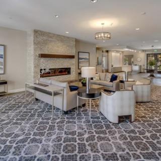 A modern and luxurious lobby featuring elegant seating, a stylish chandelier, and contemporary decor.