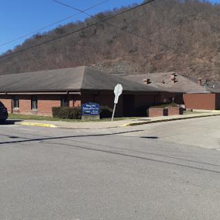 A view of a building near a mountain, showcasing the intersection of urban life and natural scenery.