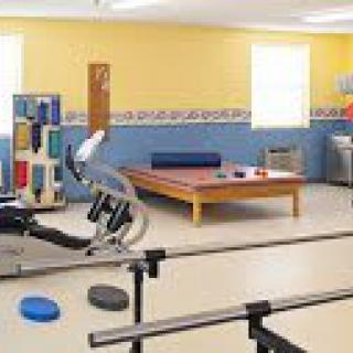 A physical therapy room equipped with various rehabilitation tools and exercise equipment.