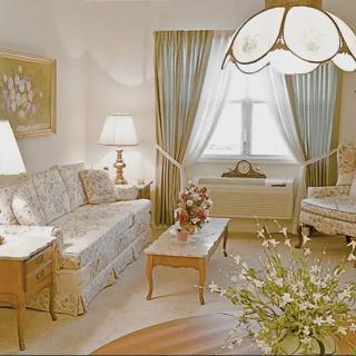 A traditional living room with elegant furnishings and soft lighting.