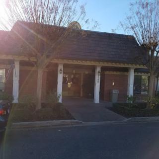 A welcoming entrance to a well-designed building, illuminated by sunlight.