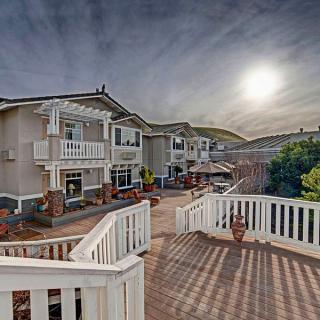 A serene residential area with houses featuring balconies under a setting sun.