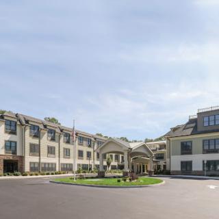 A modern hotel featuring elegant architecture and well-maintained landscaping.