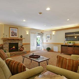 A cozy living room with a fireplace and comfortable seating.