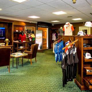 A well-organized golf shop featuring clothing and equipment displays.