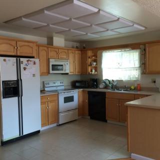 A spacious kitchen with wooden cabinets and modern appliances.