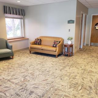 A cozy waiting area featuring comfortable seating and neutral tones.