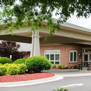 A welcoming building entrance surrounded by well-maintained landscaping.