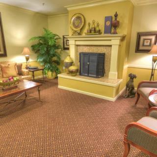 A cozy living room with a traditional fireplace and comfortable seating.