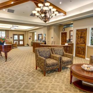 A well-appointed lobby with comfortable seating and a large chandelier.