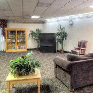 A cozy living room with comfortable seating and a large TV.