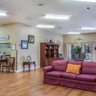 A spacious and inviting living room featuring a comfortable sofa and wooden flooring.