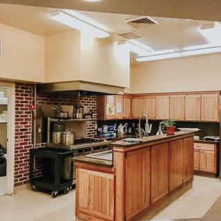 A modern kitchen interior featuring wooden cabinets and an island counter.