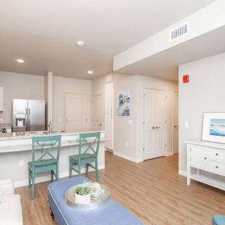 Modern apartment interior with an open kitchen and living area.