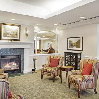 A cozy living room with a fireplace and comfortable armchairs.