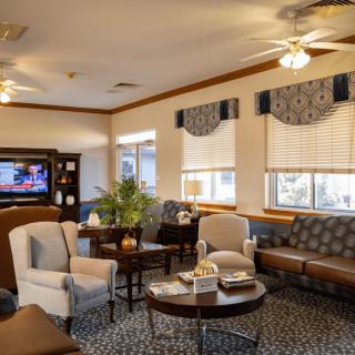 A cozy living room with comfortable seating, a TV, and elegant decor.
