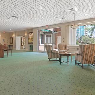 A spacious lobby area featuring comfortable seating and large windows allowing natural light.