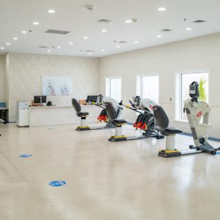A modern gym space featuring rowing machines and bright interior design.