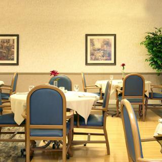 A cozy dining area featuring neatly arranged tables and chairs with decorative elements.