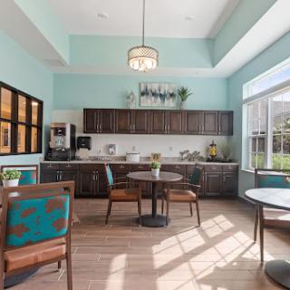 A modern kitchen and dining area featuring a bright color scheme and ample natural light.