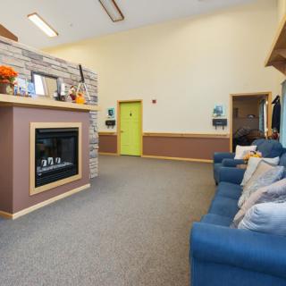 A cozy living room featuring a fireplace and comfortable sofa seating.