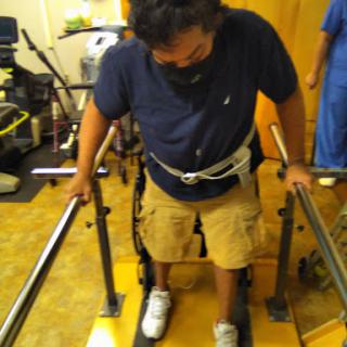 A patient using a walking aid during physical therapy.