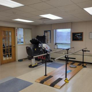 A well-equipped rehabilitation room featuring various therapy and exercise equipment.