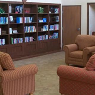 A cozy reading area with bookshelves and comfortable armchairs.