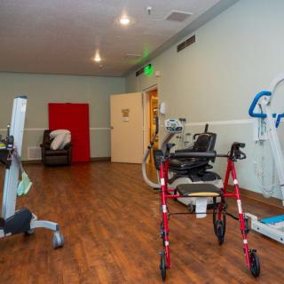 A physical therapy room equipped with various rehabilitation tools and exercise machines.