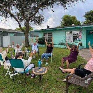 A lively outdoor gathering focused on wellness and community interaction.