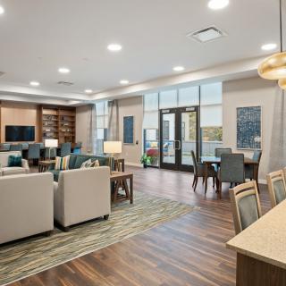 A modern living area featuring stylish furniture, elegant lighting, and wooden flooring.