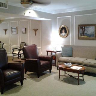 A cozy living room with armchairs, a sofa, and elegant decor.